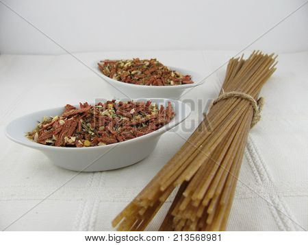 Spelt spaghetti with spice mix in a little bowl