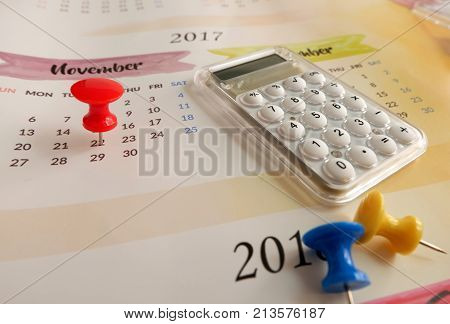 Calendar with red pin and calculator for planning concept for finance and business