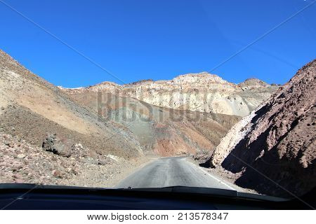 Car driving through Death Valley at Sunset.