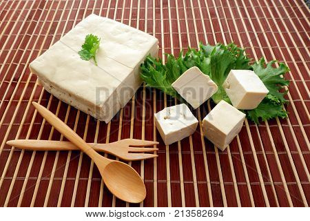 Japanese tofu, tofu soy cheese cold and soft for healthy with wooden spoon on bamboo mat