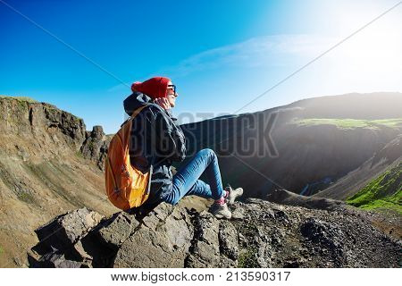back view of woman traveler on a walk in the Valley of the river of Hveragerdi Iceland. Hiking Tour of Reykjadalur Hot Springs