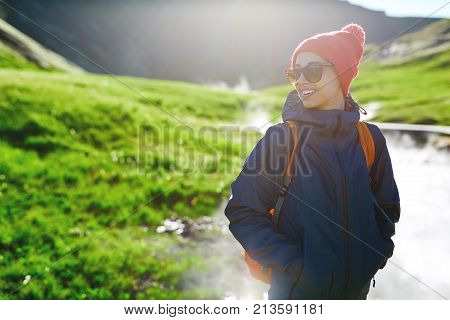 woman traveler on a walk in the Valley of the river of Hveragerdi Iceland. Hiking Tour of Reykjadalur Hot Springs