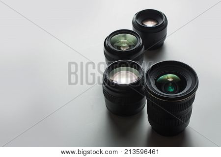 close-up view of a group of camera lenses on a white surface