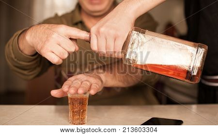 Man saying no more to alcohol with his body language
