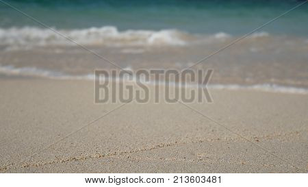 soft wave of the blue sea clear water on the white sand beach with copy space area. summer sea sandy beach for holiday background wallpaper