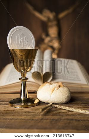 Eucharist symbol of bread and wine, chalice and host, First communion background