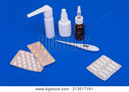 Medications, Pills And A Thermometer On A Bright Background
