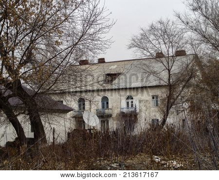 Very old building with arched windows. Old majestic white house