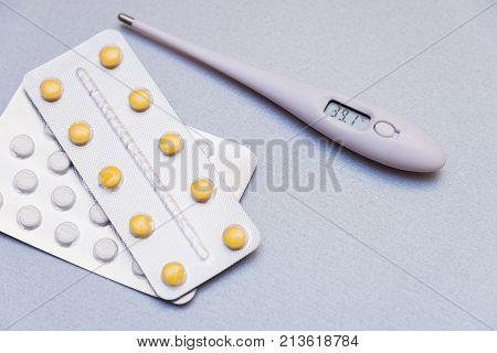 Medications And A Thermometer On A Light Background