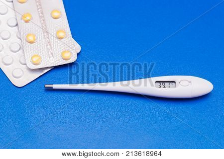 Medications, Pills And A Thermometer On A Bright Background