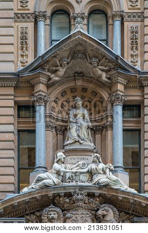 Sydney Australia - March 25 2017: Brown facade and monumental statue of Queen Victoria above entrance to historic building now Shopping mall backs Cenotaph War Memorial at Martin Place.