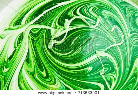 white and green emulsion . Photo of an abstract texture