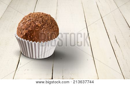 Traditional Brazilian Brigadeiro On White Wood Background