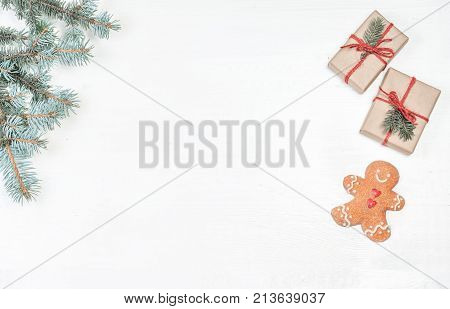 Christmas gifts fir tree branches xmas holiday decorations festive symbols on white wooden background with copyspace. Christmas composition.