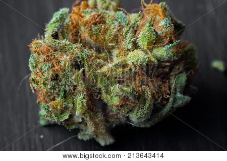 Macro photos of marijuana cones with leaves covered with trichomes. The cannabis plant clse view.