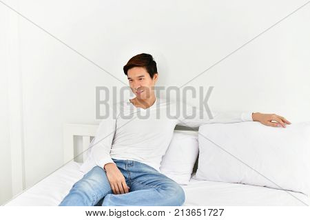 Men are playing mobile in the bedroom.