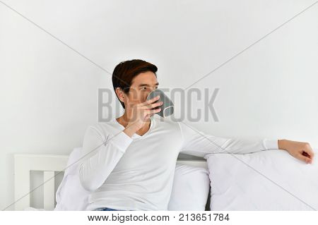Men are playing mobile in the bedroom.