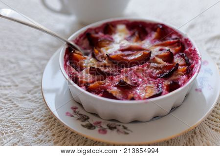 Plum clafoutis in a baking dish