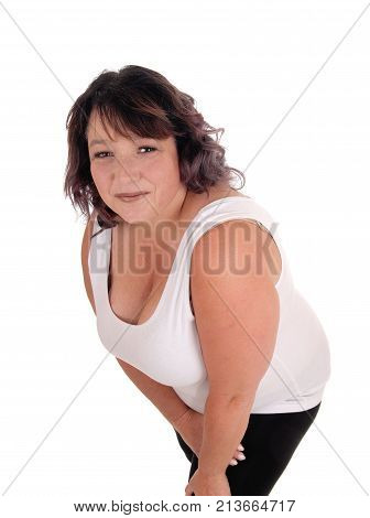 A pretty middle age woman in a white t-shirt standing isolated for white background bending forwards