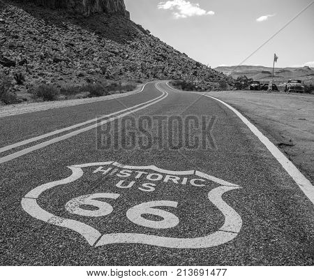 Black and white image of route 66 painted on the asphalt on a highway in Arizona.