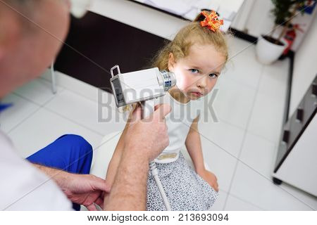 the doctor examines the special medical device moles child