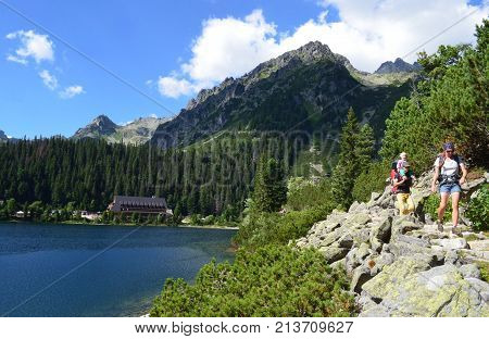 Popradske Pleso mountain lake in High Tatras mountain range in Slovakia - a beautiful sunny summer day in a popular hiking and travel destination in Central Europe