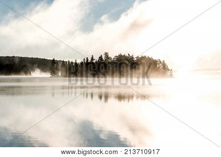 Lake of two rivers in algonquin national park ontario canada sunset sunrise with fog foggy mystical atmosphere background