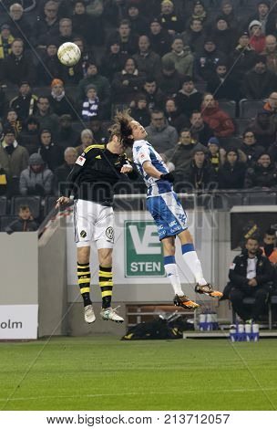SOLNA SWEDEN - OCT 30 2017: Soccer player in the game AIK and IFK Gothenburg jump and nick the ball. October 30 2017SolnaSweden