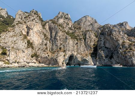 CAPRI ITALY - JUNE 13 2017: Boats with tourists near Grotta Bianca and Grotta Meravigliosa Capri Italy