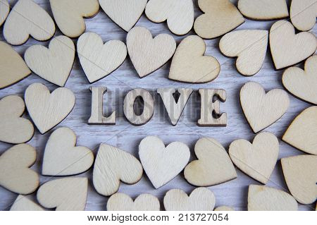 Heart shape from natural tree. Lovely heart shape by wooden small hearts on rustic wood table. Love theme concept with wooden hearts for Valentine's background and love theme. wooden leters i love you.