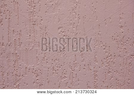 the background is made of a texture of Venetian plaster of pink color. Style bark beetle with a relief surface