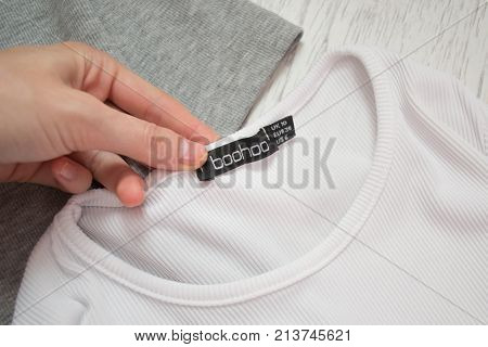 Kharkiv, Ukraine - 11 August 2017: Boohoo Black Tag On White T-shirt In A Female Hand. Close-up