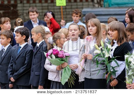 Tyumen, Russia - September 1, 2012: School 43. School line is in schoolyard with pupils and teachers. Feast Day of Knowledge.