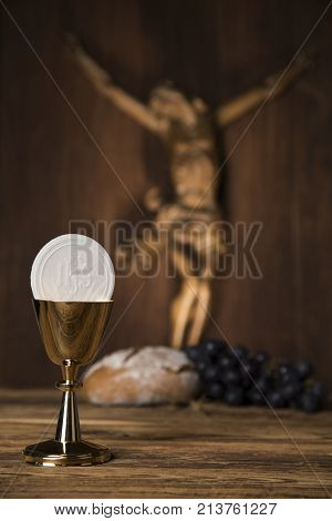 Eucharist symbol of bread and wine, chalice and host, First communion background