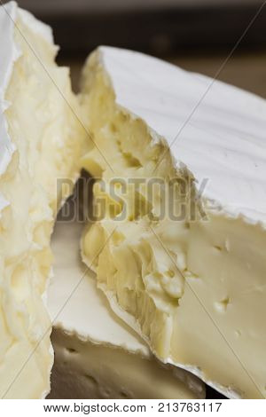 Close Up Of Camembert Cheese. Brie With Coarse Edge Broken Into Pieces Cremy And Delicious.