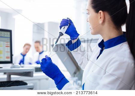Searching for advice. Beautiful concerned intern  wanting to ask her experienced colleagues about details of procedure and holding medical appliance