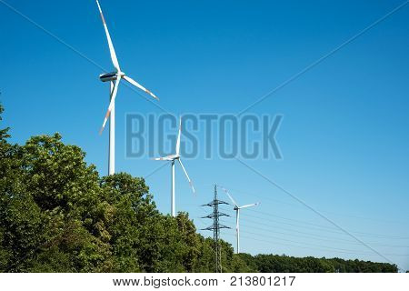 Wind power plants and trees seen in Germany