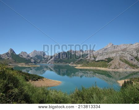 Reflection of the mountains on the river near Riano