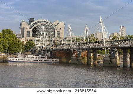 City cruise ships on the river Thames, on background Hungeford Bridge and Golden Jubilee Bridges in the morning, London England.