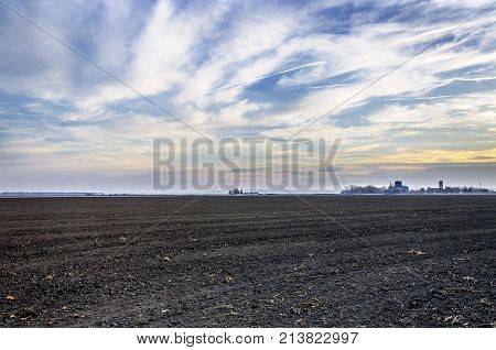 agriculture arable land field with sky clouds. agricultural landscape