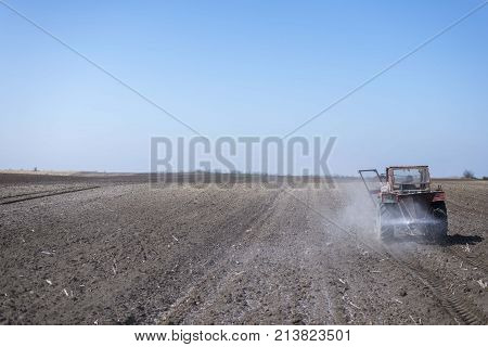 arable land landscape with tractor machine working