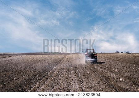 agriculture arable land field with tractor machine working