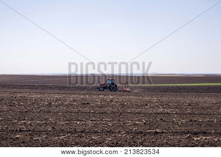 arable land landscape with tractor machine working