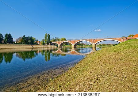 Old bridge on river Kupa on a beautiful sunny day in Sisak Croatia.