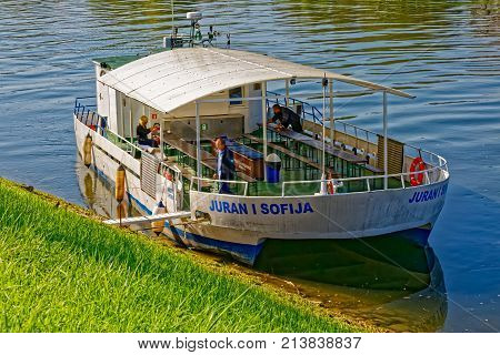 SISAK, CROATIA - September 30, 2017: Old tourist boat anchored on the river Kupa on a beautiful sunny day.