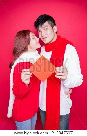 couple show couplets with chinese new year on red background