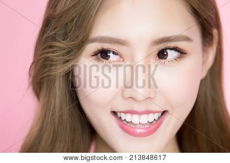 beauty skincare woman look somewhere on the pink background