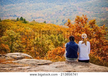 Couple getaway hiking at fall sitting together