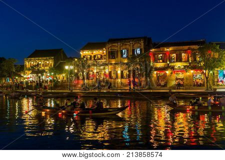 Hoi An Vietnam - February 2 2017: Street view with traditional boats on a background of ancient town in Hoi An Vietnam