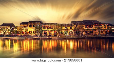Hoi An Vietnam - February 2 2017: Street view with traditional boats on a background of ancient town in Hoi An Vietnam